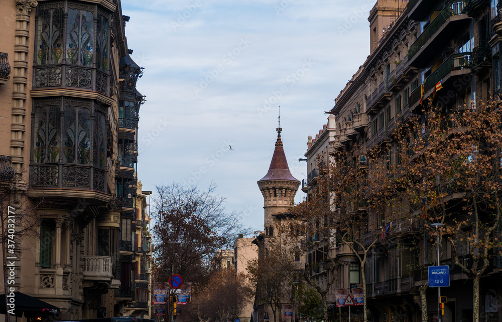Fototapeta premium Buildings in streets of Barcelona with a tower in background