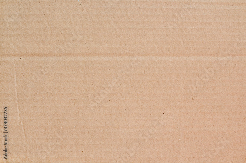 Cardboard sheet texture background, detail of recycle brown paper box pattern.