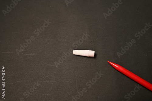 The red marker isolated on black background photo