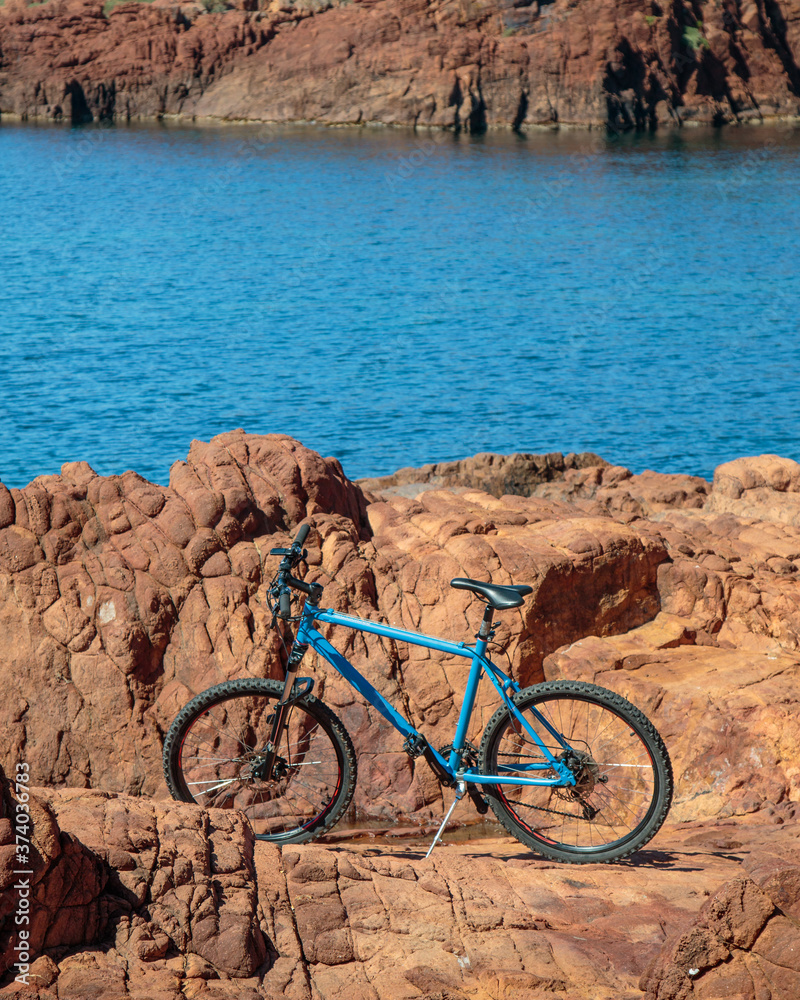 blue mountain bike on a rocky seashore