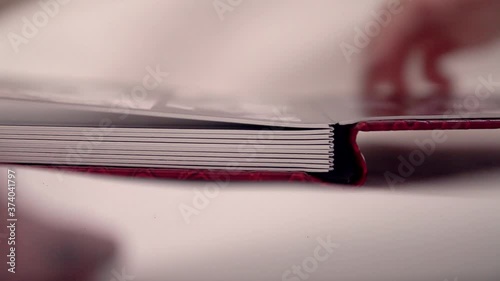 Diary book close-up on a white background. red cover made of crocodile skin. the best gift - a photo album. page turning
