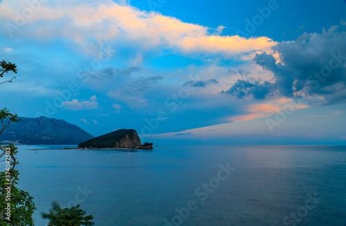 Fototapeta Naklejka Na Ścianę i Meble -  Sunset view of Island of St. Nicholas or Hawaii, small island in the Adriatic sea near Budva Montenegro