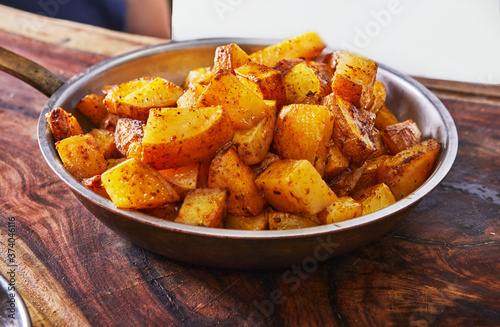 A plate of golden potatoes with a special sauce