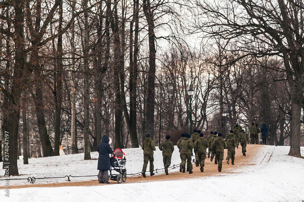 Russian cadets of the military school running in the winter park