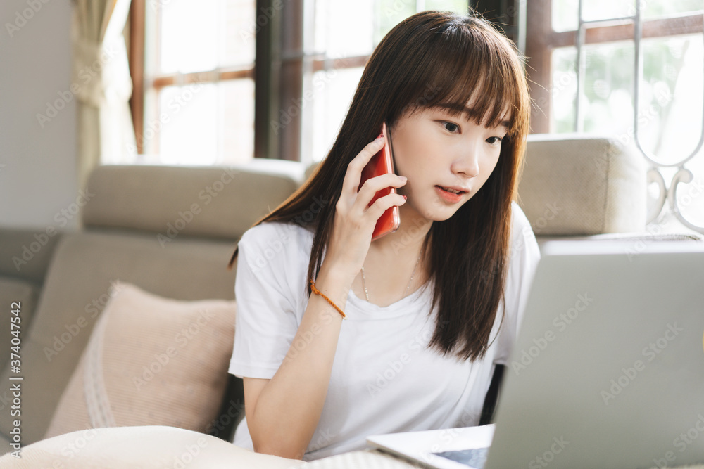 Teenager asian student woman education online via internet at home talk by mobile phone Teenager asian student woman education online via internet at home talk by mobile phone