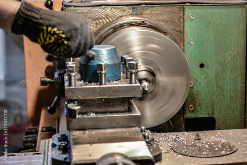 Working on a lathe, a cutter removes chips from the workpiece surface being processed.