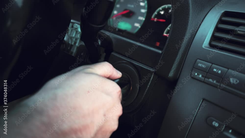 man turns on the car's ignition key man turns on the car's ignition key