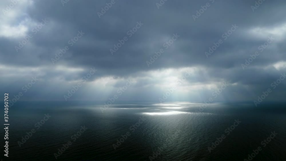 Scenic seascape. Beautiful rays of sun breaking through the clouds over The Black sea. 4K