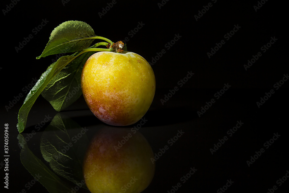 Ripe plums on a black background