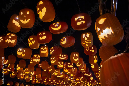 Hundreds of Jack-o-lanterns hang in the air.