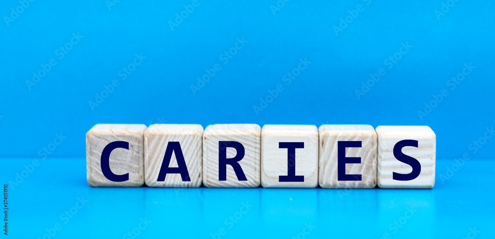 concept word CARIES on cubes on a blue background concept word CARIES on cubes on a blue background