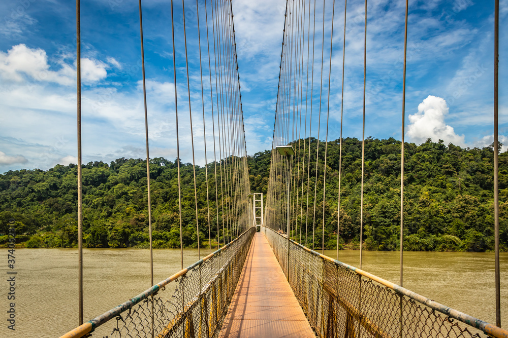 suspension iron bridge isolated with bright blue sky from unique different angle suspension iron bridge isolated with bright blue sky from unique different angle