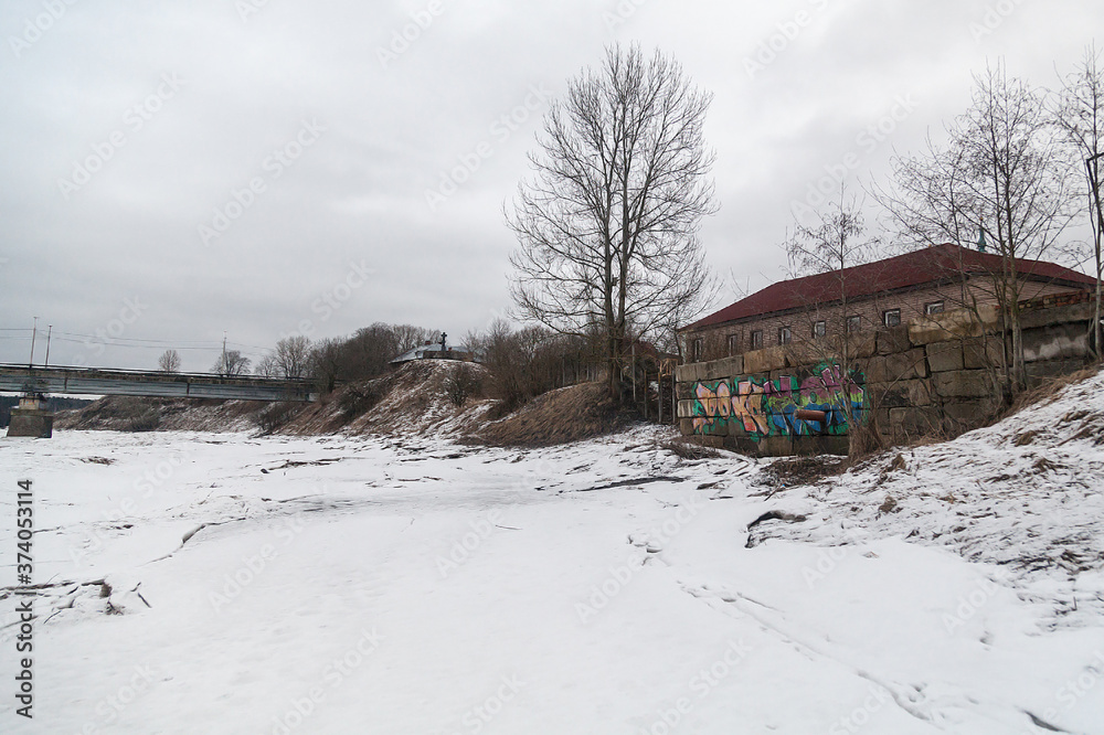 Winter landscape of a small Russian village on the river bank Winter landscape of a small Russian village on the river bank
