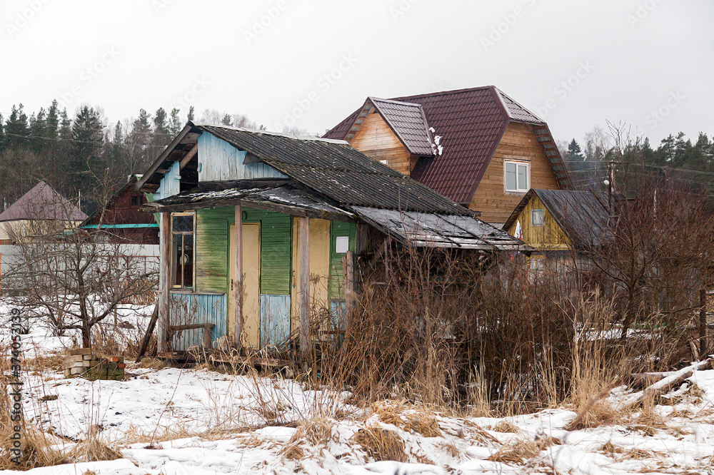 Russian village house next to a spring road Russian village house next to a spring road