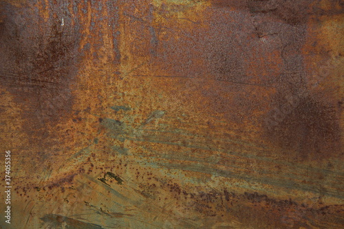 Еexture of rusty iron, cracked paint on an old metallic surface, sheet of rusty metal with cracked and flaky paint, abstract rusty metal texture. Horizontal