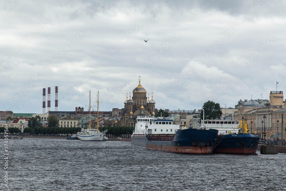 Vasilievskiy island cloudy cityscape. Neva river embankment