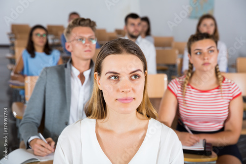 Portrait of attentive female student on training session in lecture hall..