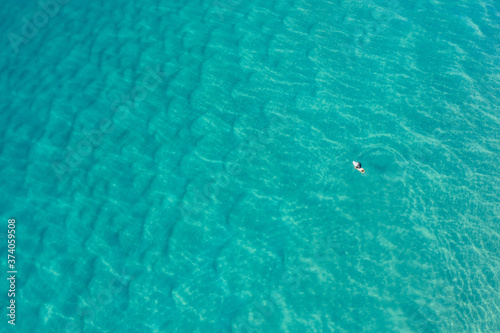 Aerial view surfers at Alexandra Bay, Noosa National Park photo