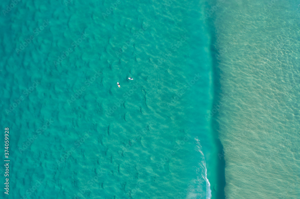 Aerial view surfers at Alexandra Bay, Noosa National Park