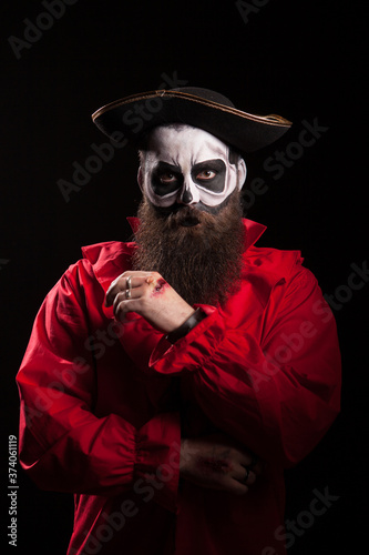 Man dressed up like a pirate for halloween with blood on his hand.