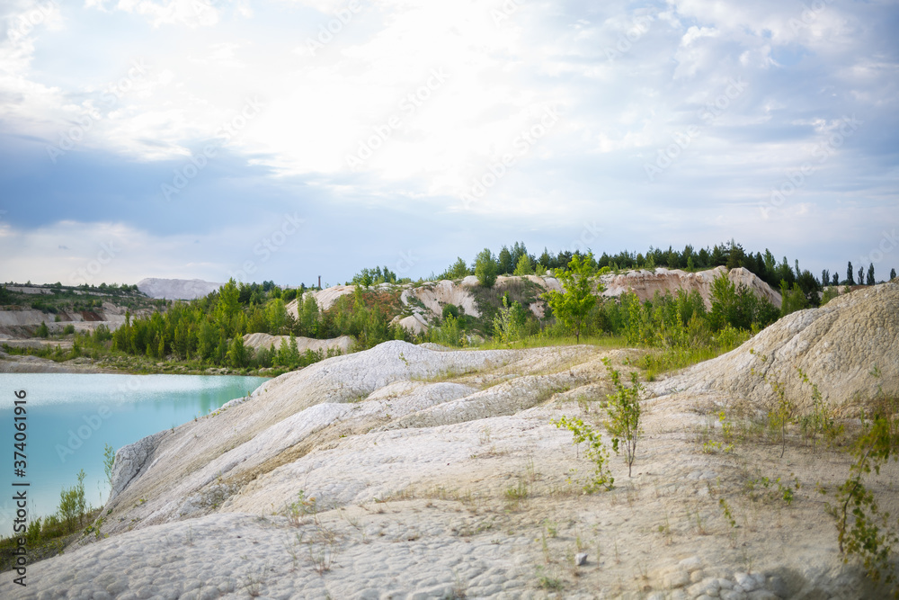 Aerial spectacular view to scenic valley with beautiful mountain lake, conifer forest and rocky mountains. Amazing atmospheric highland landscape. Wonderful majestic wilderness nature scenery.