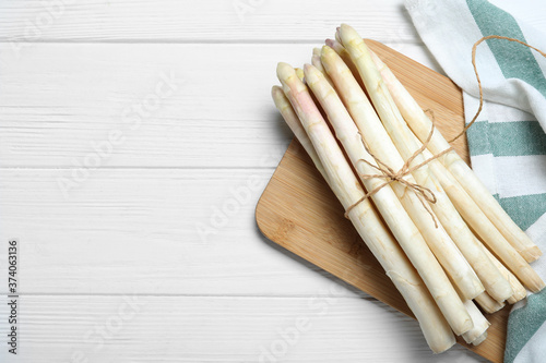 Fresh white asparagus on wooden table, top view. Space for text