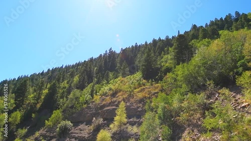 Slow motion pov point of view low angle driving in vehicle car on scenic road in Colorado on Million Dollar Highway 550 at San Juan national forest with canyons on route from Ouray to Durango photo