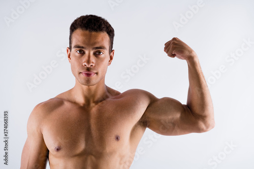 Closeup photo of handsome muscular sportsman dark skin guy showing strong biceps arm ideal body shapes figure naked chest topless macho isolated white color background