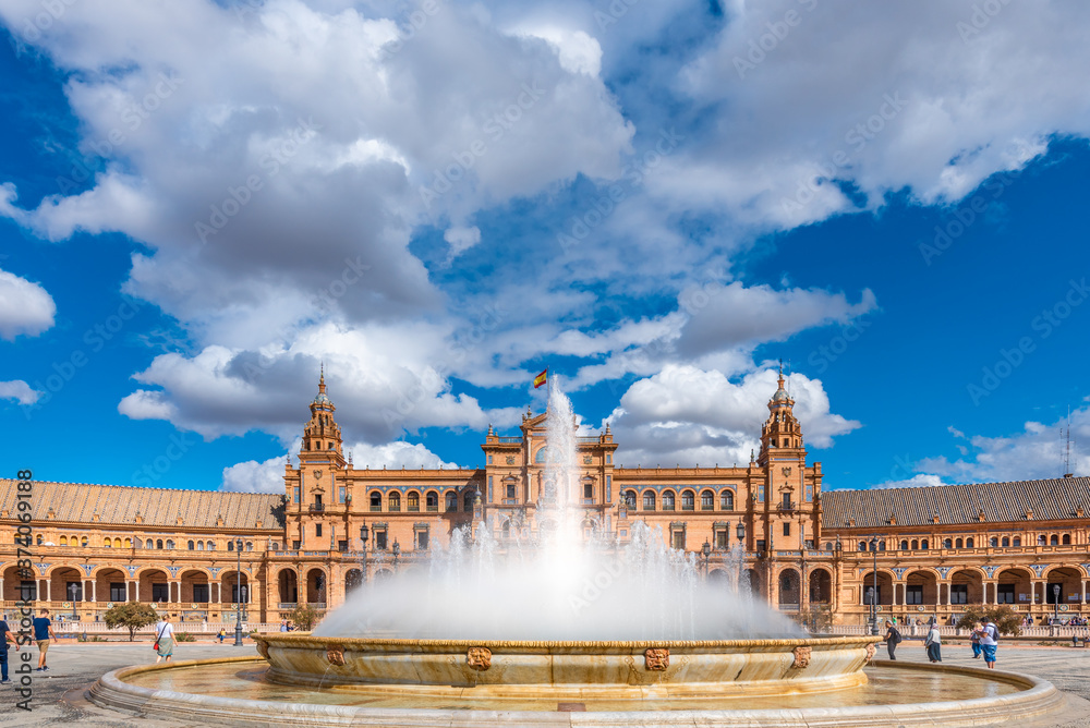 Seville, Spain. October 14th, 2019.  Plaza de España with tourists strolling admiring the amazing palace and fountain.