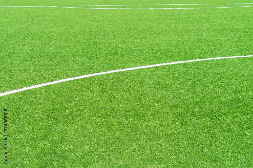 Green artificial grass turf soccer football field background with white lines. Top view