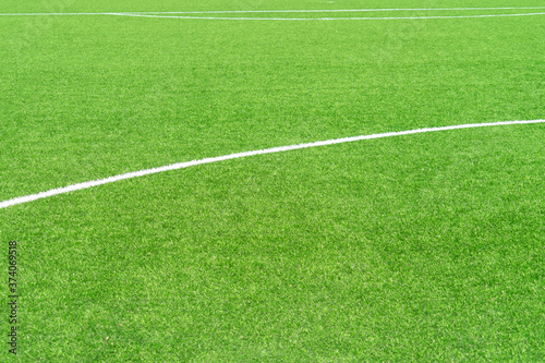 Green artificial grass turf soccer football field background with white lines. Top view