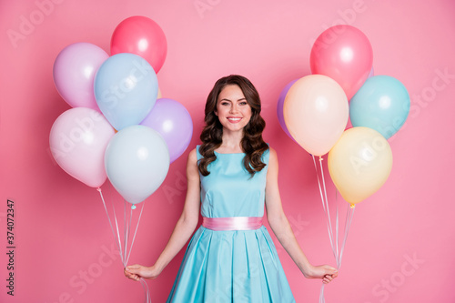 Photo of pretty funny lady celebration event party hold both hands many air balloons birthday overjoyed emotions wear blue teal mini dress skirt isolated pink pastel color background © deagreez