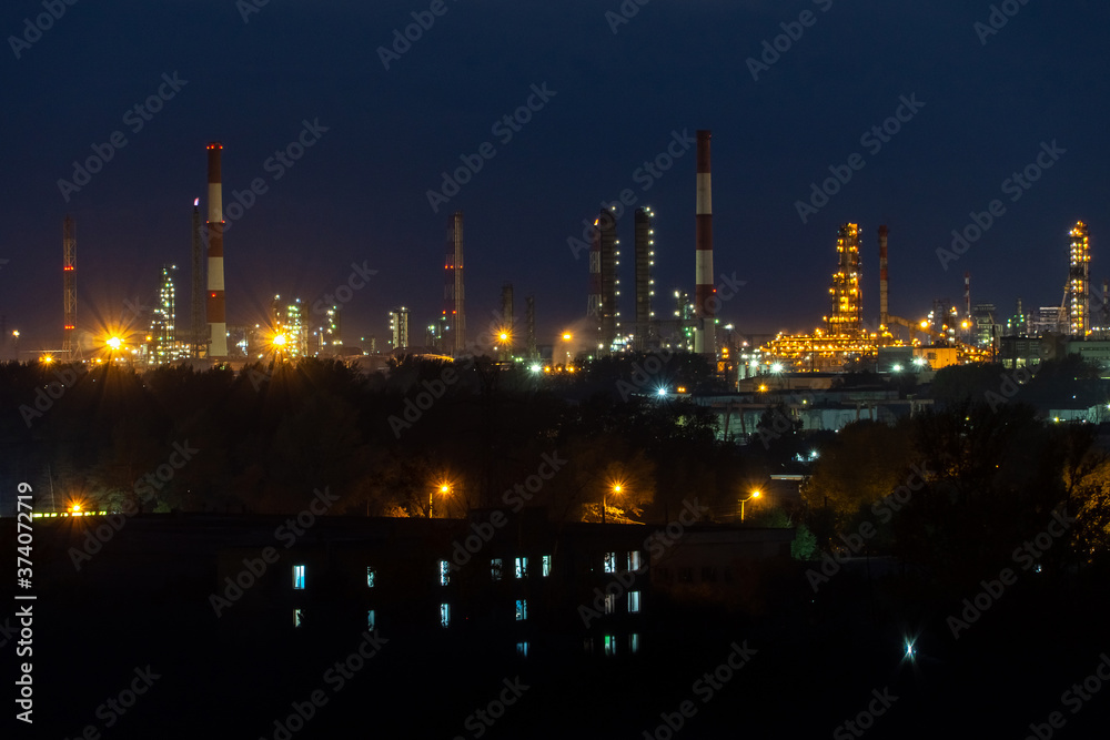 oil refinery lights against the night sky