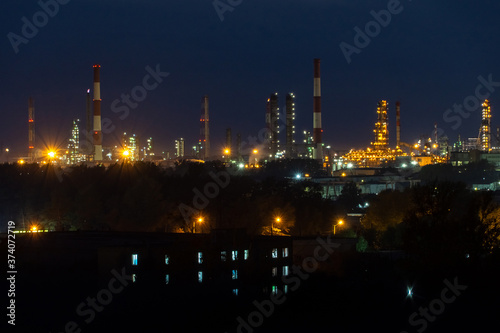 oil refinery lights against the night sky