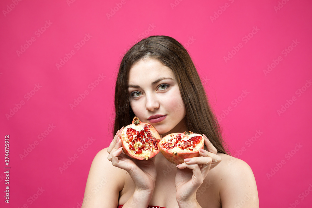 Smiling woman with grapefruit cut in half fruit in hand