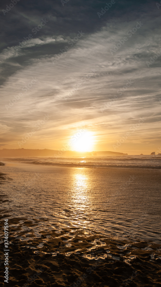 Naklejka premium Sunset by the beach