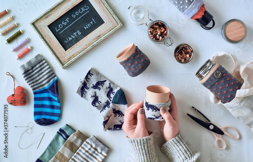 Zero waste household. Making bamboo cups out of stray socks. Upscale of orphaned mismatched socks. Flat lay on white textile. photo