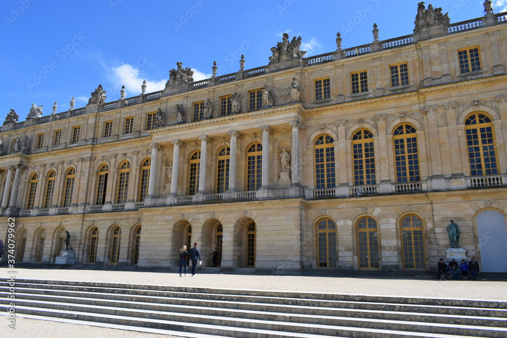 Versailles, France - May 02, 2018: Palace of Versailles, not far away from Paris. It is one of the most visited attractions in France. Great cloudy blue sky,