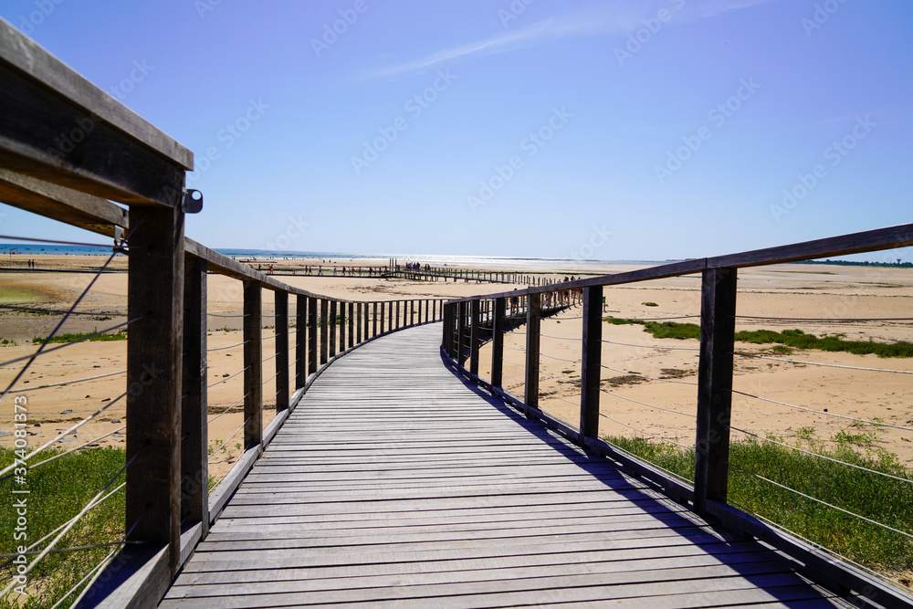 wooden path access dune sand beach of Jard sur Mer in atlantic ocean France wooden path access dune sand beach of Jard sur Mer in atlantic ocean France