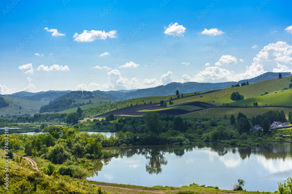 Landscape with hills and lake on a Sunny day, blue sky with clouds. Russia, Altai territory Landscape with hills and lake on a Sunny day, blue sky with clouds. Russia, Altai territory