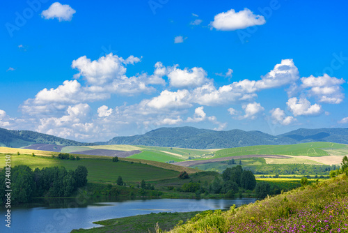 Landscape with hills and lake on a Sunny day, blue sky with clouds. Russia, Altai territory © Владимир Зубков