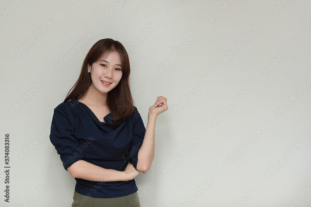 Asian business woman smiling and gesturing on gray background. Asian business woman smiling and gesturing on gray background.