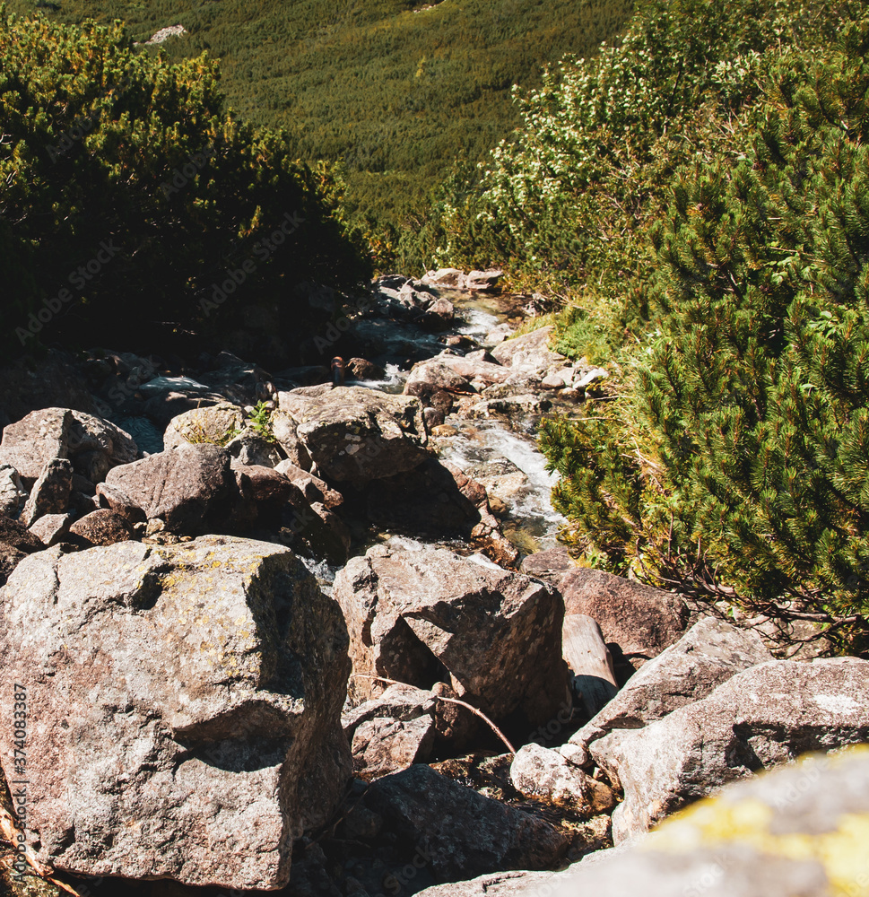 Water flowing rapidly through a set of stones nicely placed in the mountain river. Water flowing rapidly through a set of stones nicely placed in the mountain river.