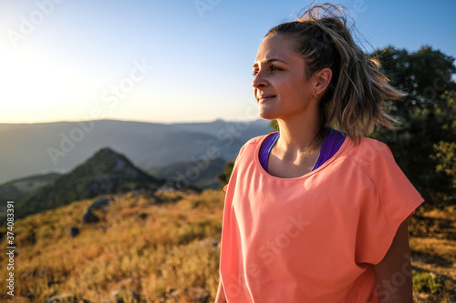 Young latin blonde woman laughing as the sun sets