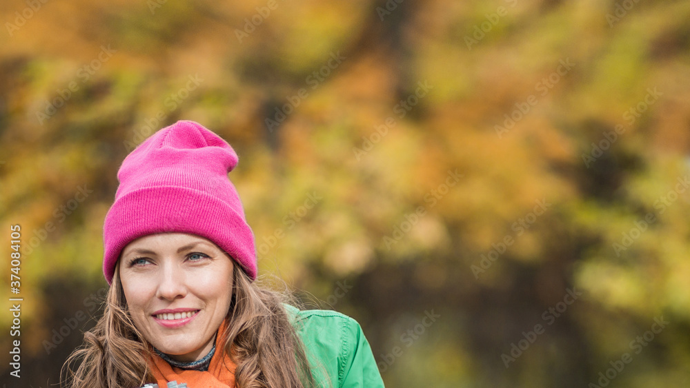 Carefree young woman in autumn park enjoying good warm weather Carefree young woman in autumn park enjoying good warm weather