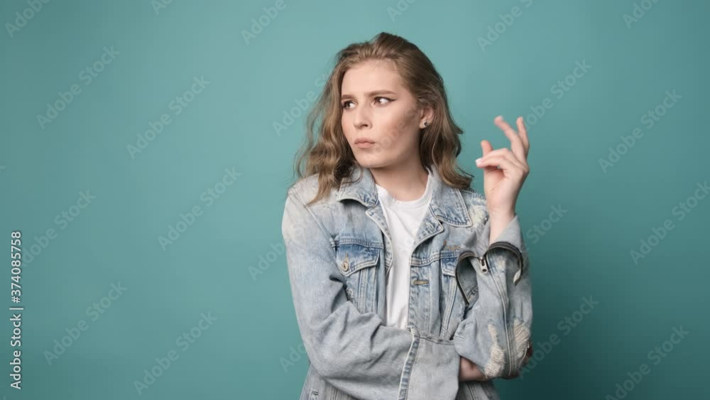 I have great idea. Studio shot of attractive female moving fingers near chest as if making up plan in mind, raises her finger up showing that she has a wonderful idea. I have great idea. Studio shot of attractive female moving fingers near chest as if making up plan in mind, raises her finger up showing that she has a wonderful idea.