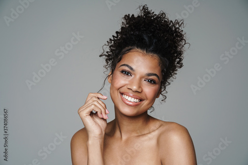 Image of shirtless african american woman looking and smiling at camera