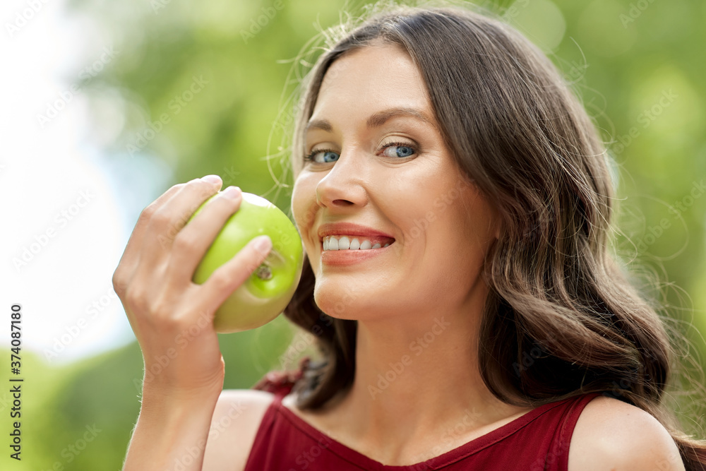 healthy eating, dental and people concept - portrait of happy woman with green apple at summer park healthy eating, dental and people concept - portrait of happy woman with green apple at summer park