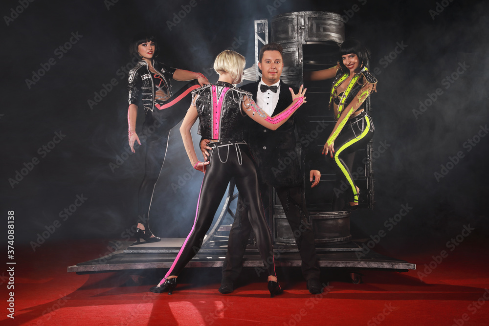 Fototapeta premium Magician performer and beauty girls show trick with box illusion on the ring in circus