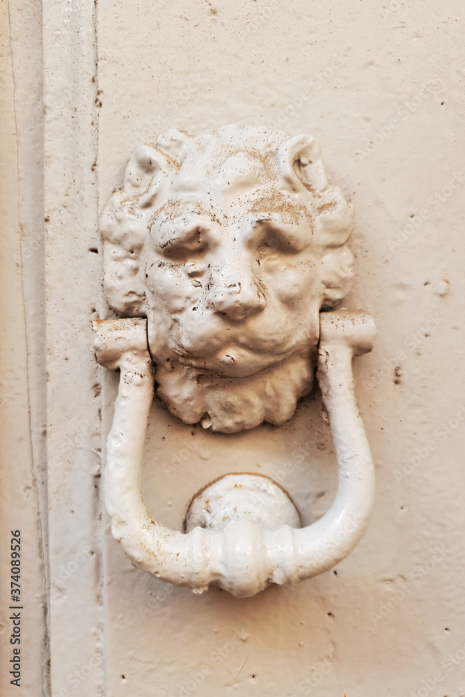 Old Italian lion-shaped front door knocker. 27 August 2020, Rome, Italy